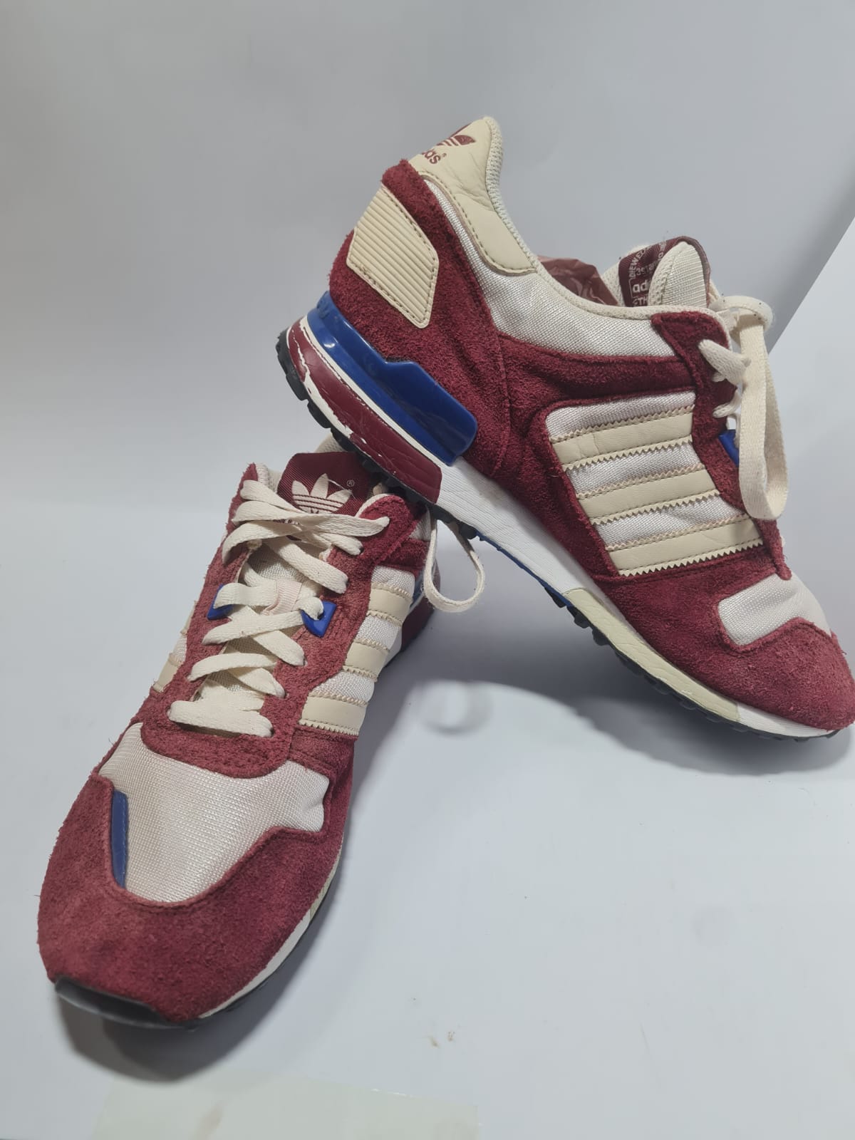 Adidas Originals ZX 700 trainers in a red and white colorway.