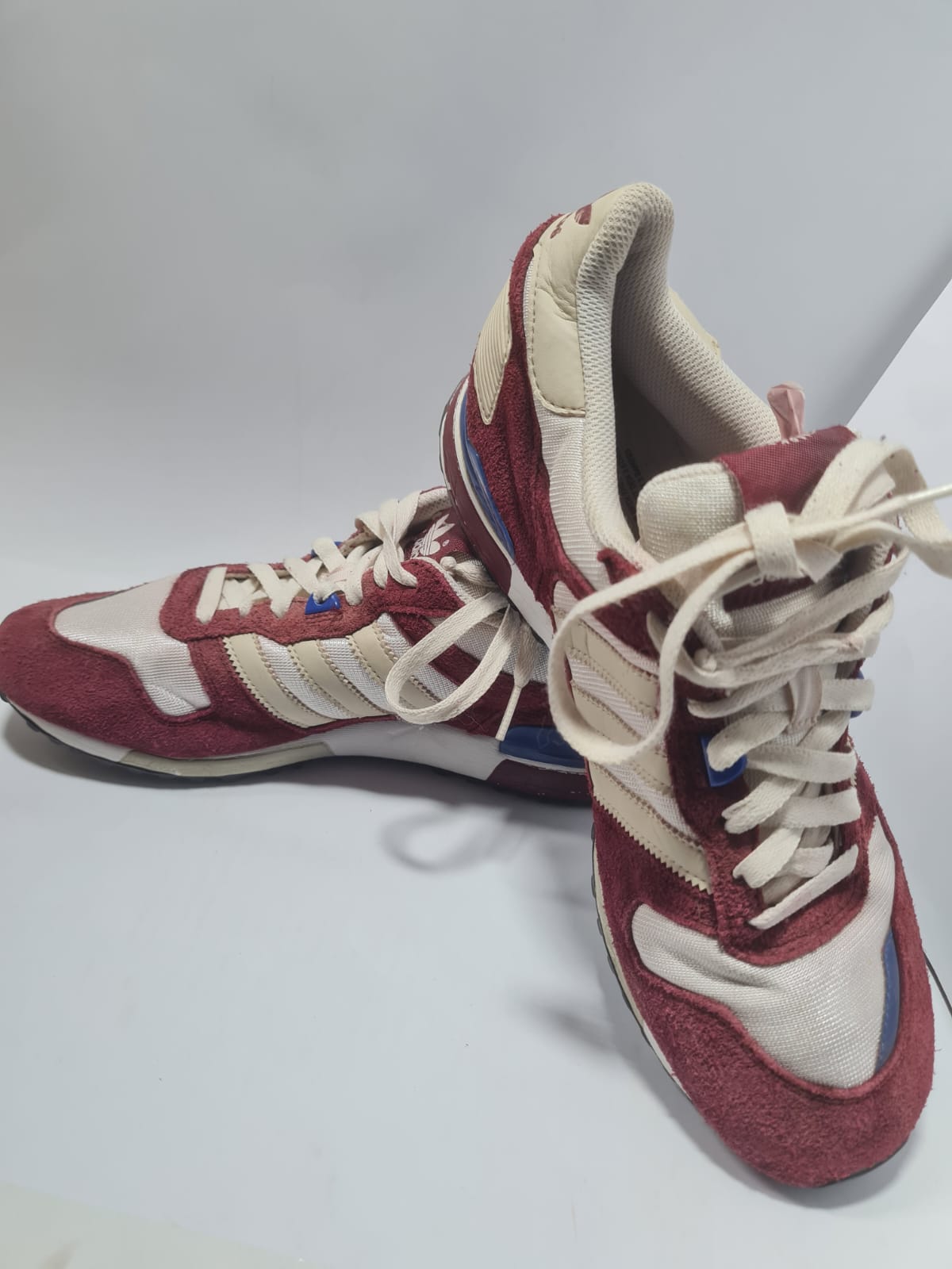 Adidas Originals ZX 700 trainers in a red and white colorway.