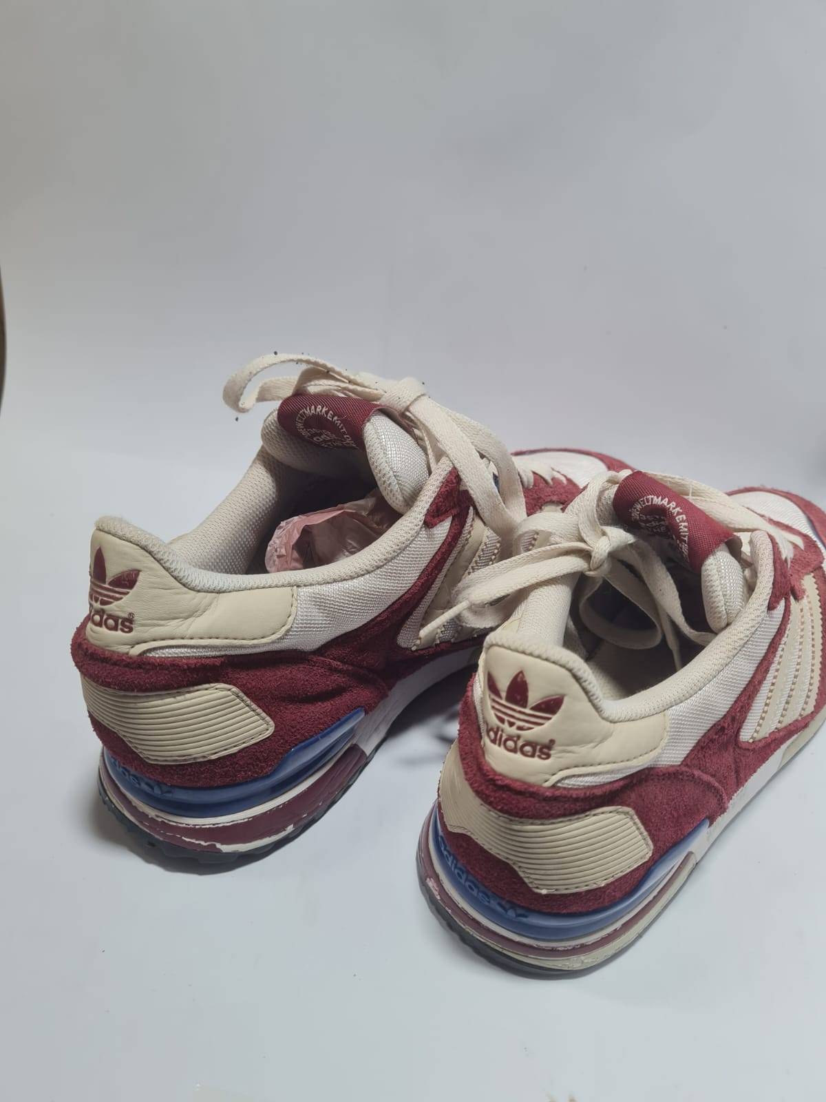 Adidas Originals ZX 700 trainers in a red and white colorway.